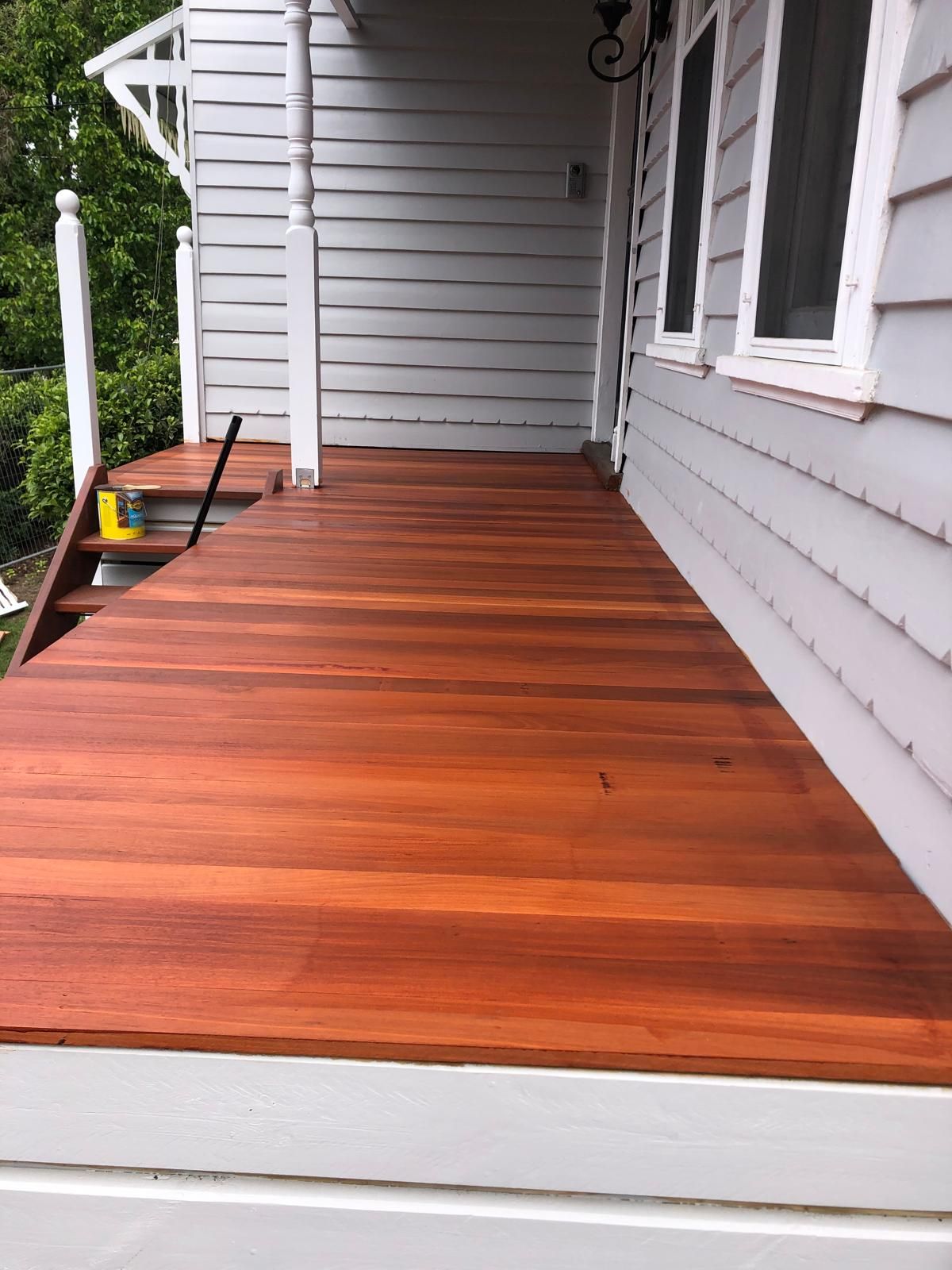 Rich hardwood deck built beside a weatherboard home