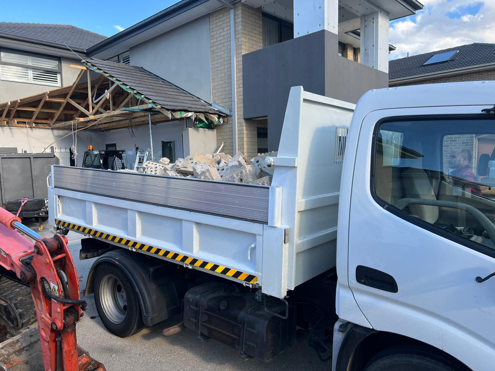 White tipper truck from the earthworks business parked on a job